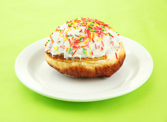 Tasty donuts on color plate on color background