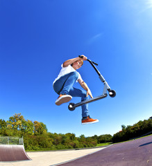 boy jumping with his scooter