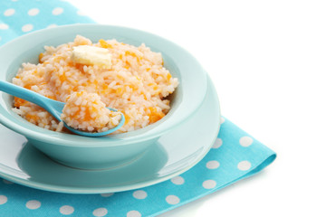 Taste rice porridge with pumpkin in blue bowl, isolated