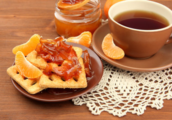 light breakfast with tea and homemade jam, on wooden table