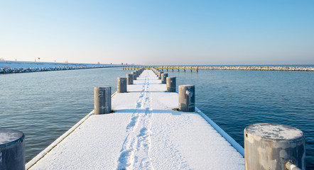 Jetty covered in snow in winter