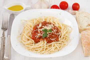 spaghetti with sauce and cheese on the plate