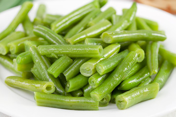 boiled green beans on the white plate