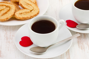 cup of coffee with cookies and red heart