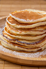 Pancakes on a wooden plate