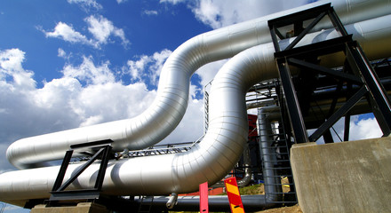 Industrial zone, Steel pipelines and valves against blue sky