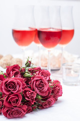 Roses and several glasses of rose wine