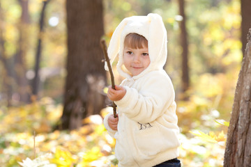 beautiful little girl in costume bunny in the autumn forest