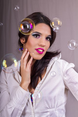 beautiful girl playing with soap bubbles