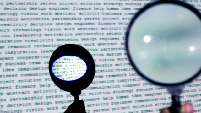 Round loupe moves over text projection on wall