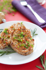 two pieces of fried meat, sprinkle with greens