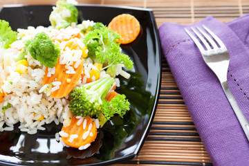 boiled rice with mix vegetables in black dish