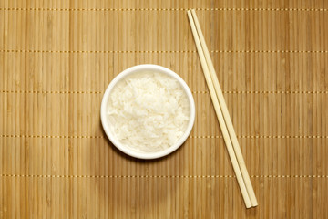 Rice on bamboo mat closeup with chopsticks