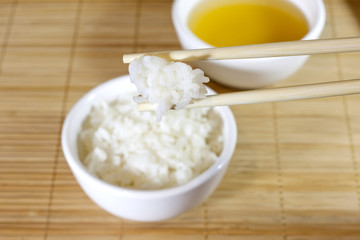 Rice on bamboo mat closeup with chopsticks
