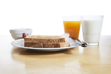 Breakfast with orange juice, milk, toast