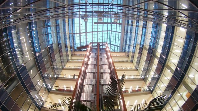 Two elevators go to business-center where light in windows of