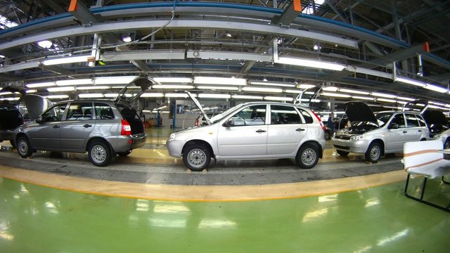 Workers do car complete set in assembly shop