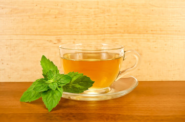Herbal tea with mint on a wooden board