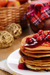Delicious pancakes with raspberries on the kitchen  table