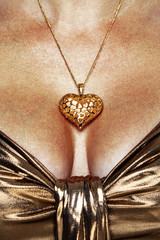 Woman wearing gold necklace and dress