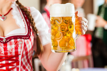 Young people in traditional Bavarian Tracht in restaurant or pub