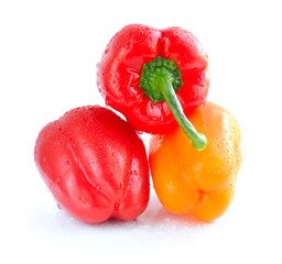 Orange and red pepper isolated on white background