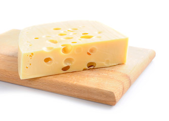 Piece of cheese on a wooden board on a white background