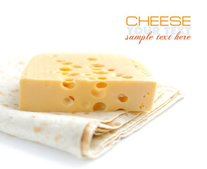 Piece of cheese on a pita on a white background