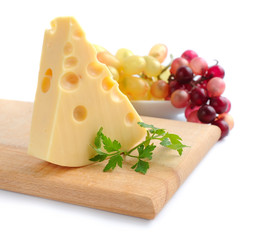 Piece of cheese on a wooden board on a white background