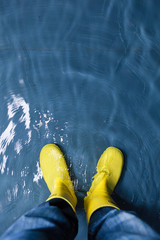 rubber boots in the water - climate concept