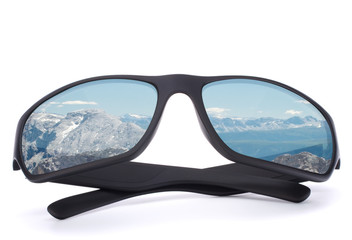 Black sunglasses with mountain reflection on isolated white back