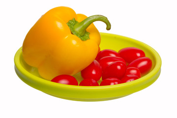 yellow pepper and cherry tomatoes on a green plate