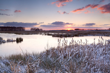 sunrise over lake in winter