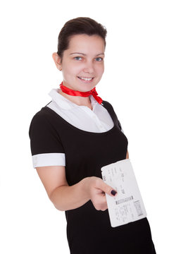 Stylish flight attendant with ticket