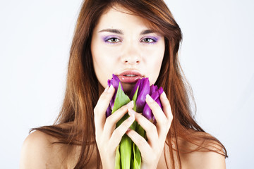 Beautiful girl with bunch of spring flowers