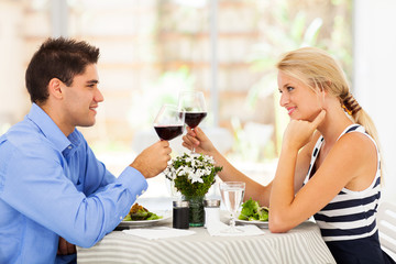 young couple drinking wine in modern restaurant