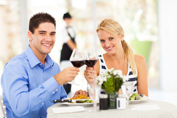 young couple drinking wine in restaurant