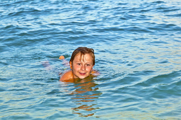 boy enjoys the beautiful water of the ocean