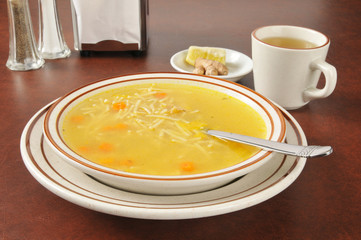 Chicken noodle soup with tea, lemon and ginger