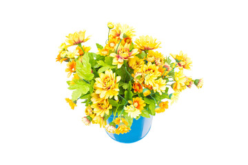 Plastic yellow flowers with metal blue vase hang on the wall.