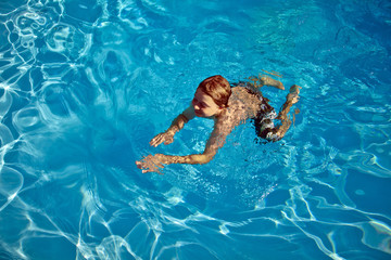child swims in the pool