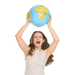 Happy young woman rising up globe