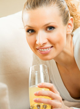 Happy woman drinking juice