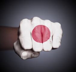 Front view of punching fist on gray background