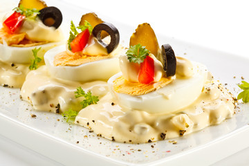 Boiled eggs with mayonnaise and vegetables