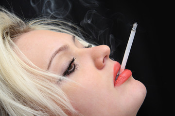 Obraz premium young girl smokes cigarette.