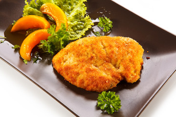 Pork chop, peaches and vegetable salad