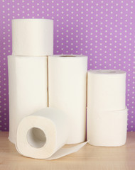 Rolls of toilet paper on purple with dots background