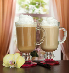 Fragrant coffee latte in glasses cups with vanilla pods,