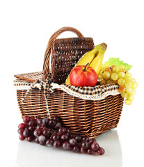 Picnic basket with fruits isolated on white